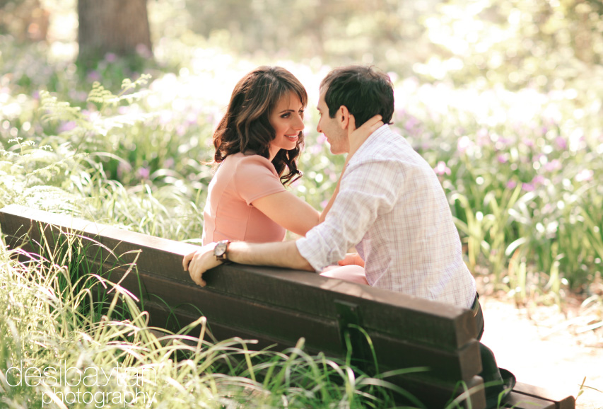 couple on park bench looking into each other's eyes